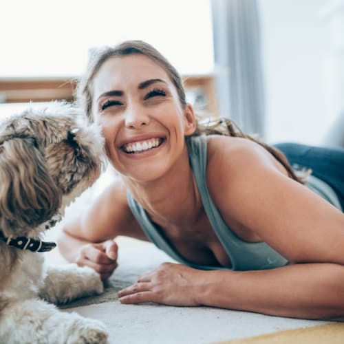 a resident getting kisses from her dog at Copper Canyon in Twentynine Palms, California