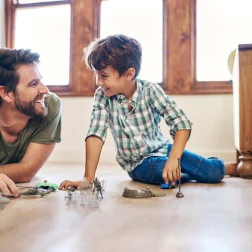 a father and son playing with toys at Copper Canyon in Twentynine Palms, California