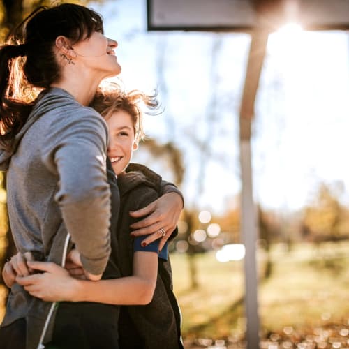 a resident and her son celebrating the perfect basketball shot at Shadow Mountain in Twentynine Palms, California