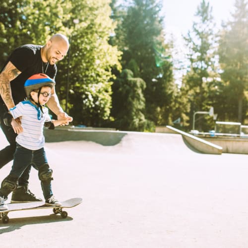 a resident teaching their child to skateboard at Shadow Mountain in Twentynine Palms, California