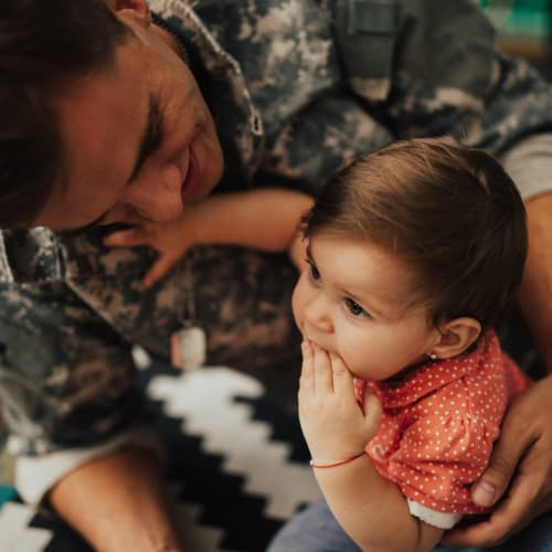 a mother with her infant on the floor at 16th Street in Yuma, Arizona