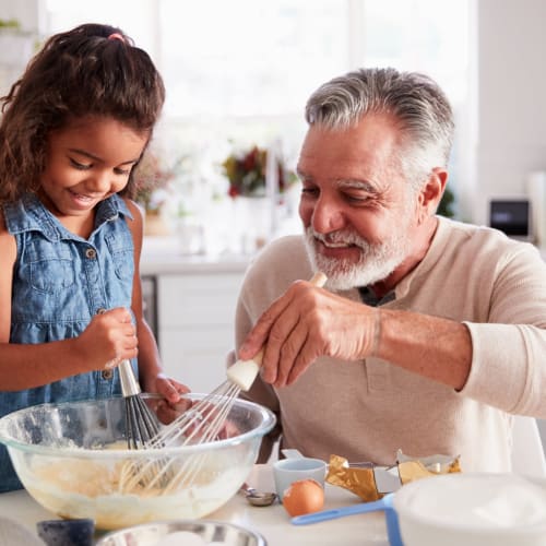  Father and daughter baking together at North Severn Village in Annapolis, Maryland