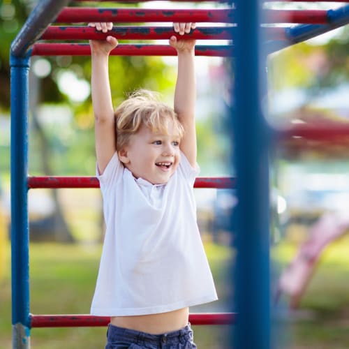 a boy on a playground at Coral Sea Cove in Port Hueneme, California