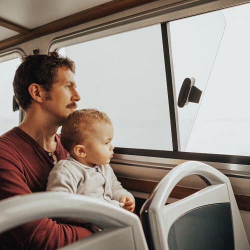 a resident sitting on the bus with his infant at Santa Cruz in Point Mugu, California