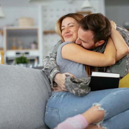 a couple embracing on the couch at San Miguel in Point Mugu, California