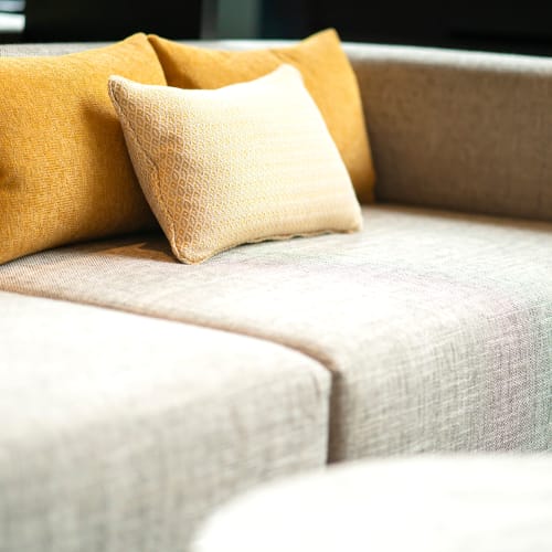 Decorative pillows on the couch in a model apartment at Vantage Park Apartments in Seattle, Washington