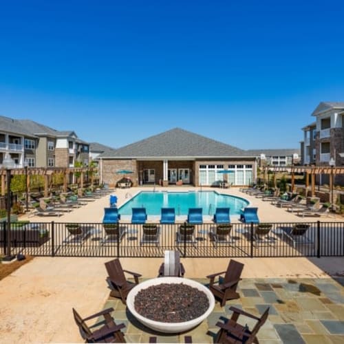Firepit, outdoor lounge seating, and a gas grilling station at Haywood Reserve Apartment Homes in Greenville, South Carolina