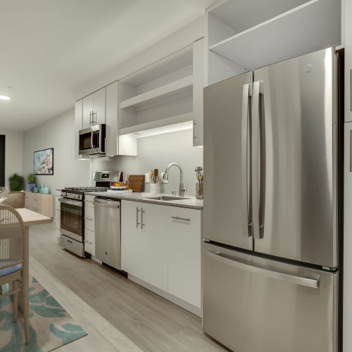 Kitchen with White Cabinets and Stainless Steel Appliances The Columbia at the Waterfront in Vancouver, Washington