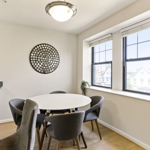 Cute dining area with an overhead light and large windows at 1630 R St NW in Washington, District of Columbia