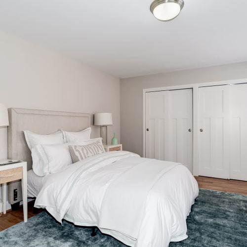 Furnished bedroom in model home that has large windows across from the bed at Bristol House in Washington, District of Columbia