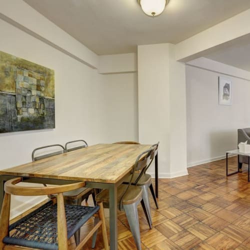 Amazing wood style flooring in the dining area with a large table for you and friends to eat on at Dorchester House in Washington, District of Columbia