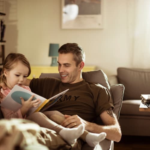 a father teaching his daughter to read at Wire Mountain II in Oceanside, California