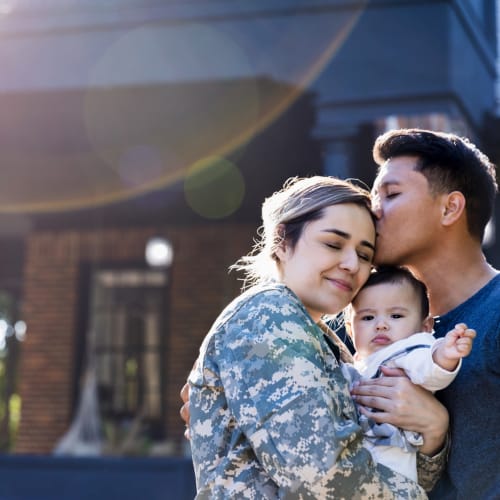 a resident family embracing in a hug at Heartwood in Joint Base Lewis-McChord, Washington