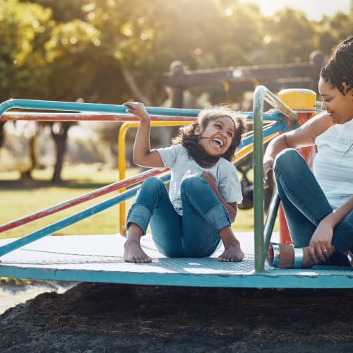 a mother and daughter on a playground at Beachwood North in Joint Base Lewis McChord, Washington