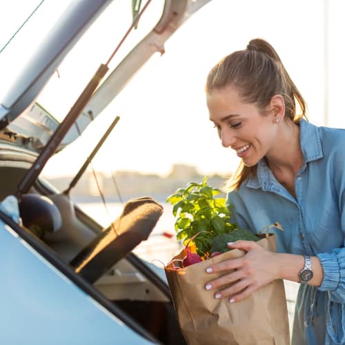 a resident getting groceries from her car at Beachwood North in Joint Base Lewis McChord, Washington