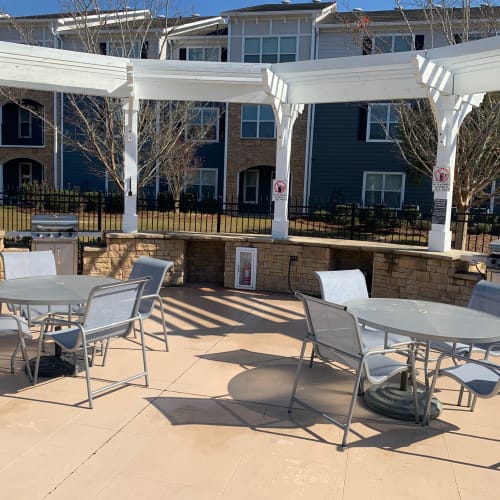 Firepit, outdoor lounge seating, and a gas grilling station at Parc at Flowing Wells Apartment Homes in Augusta, Georgia