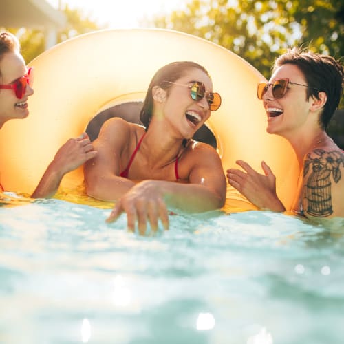 three residents in the pool at Miramar Townhomes in San Diego, California