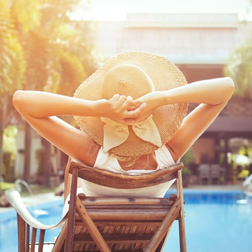 a resident sitting by the pool at Bradford Cove in Virginia Beach, Virginia