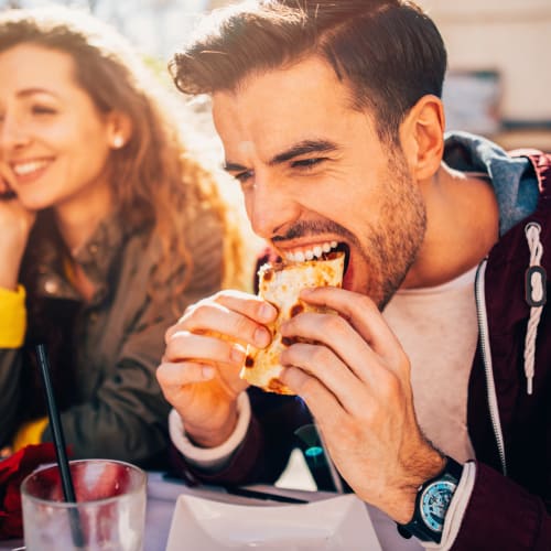 a man eating a sandwich near at Miramar Townhomes in San Diego, California