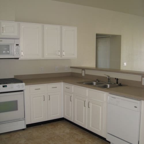 A kitchen with appliances in a home at Kansas City in Belton, Missouri