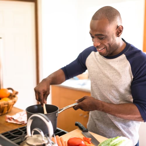 a resident cooking in his kitchen at Capeharts in Ridgecrest, California