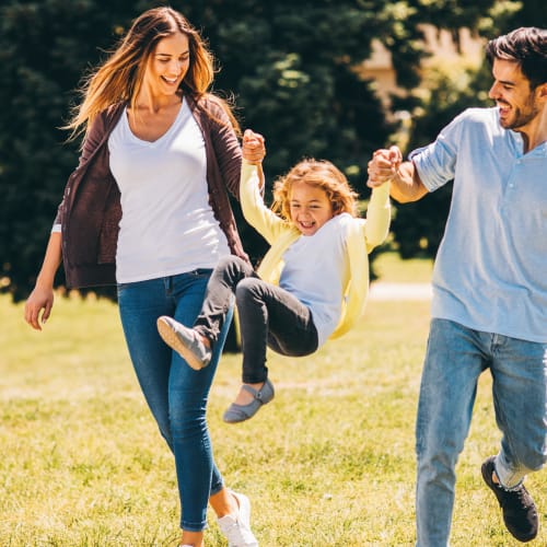 parents swinging their child at Edson in Oceanside, California