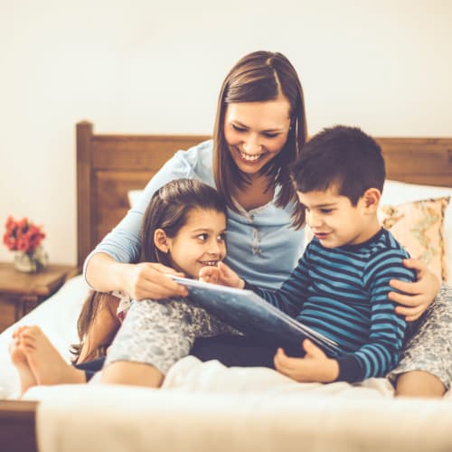 a family reading at home at Edson in Oceanside, California