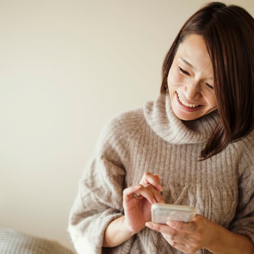 a resident at home on her phone at Edson in Oceanside, California