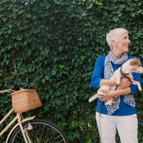 a resident with her dog and her bike at Forster Hills in Oceanside, California