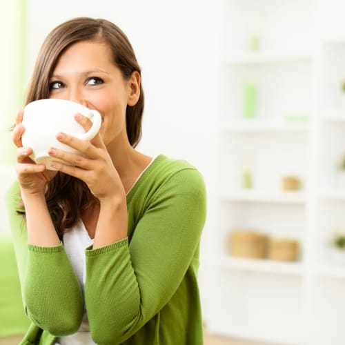 a resident sipping on some coffee at Norwich Manor in Norfolk, Virginia