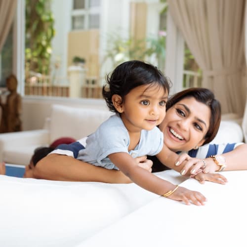 a mother and daughter smiling in the living room at Norwich Manor in Norfolk, Virginia