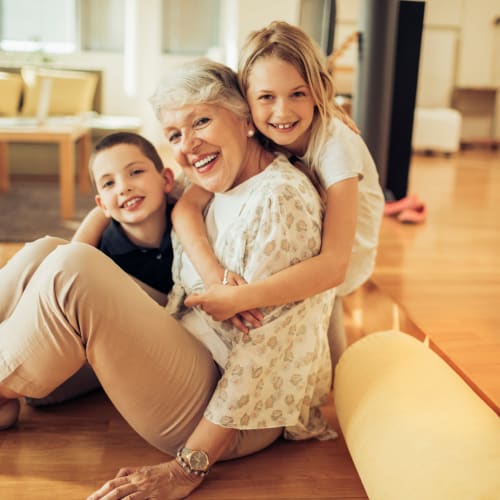 a resident family smiling on the couch at Norwich Manor in Norfolk, Virginia