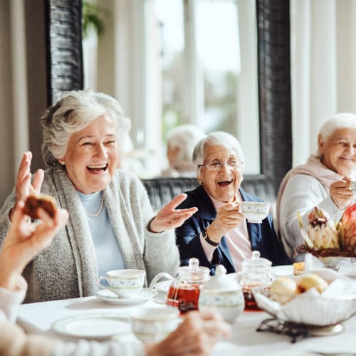 Group of residents having tea and biscuits at Saddlebrook Oxford Memory Care in Frisco, Texas