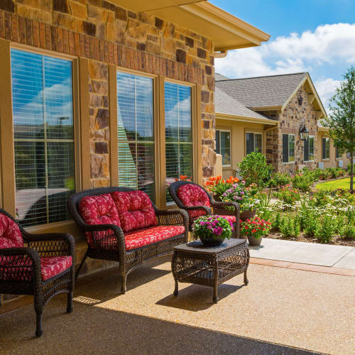 Wicker chairs on the front deck at Saddlebrook Oxford Memory Care in Frisco, Texas