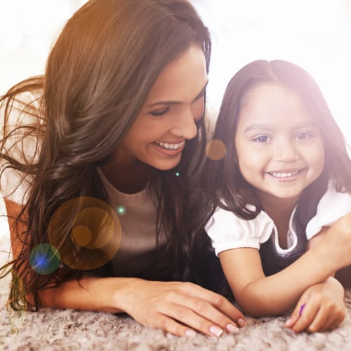 a mother and daughter laughing together at Howard Gilmore Terrace in La Mesa, California