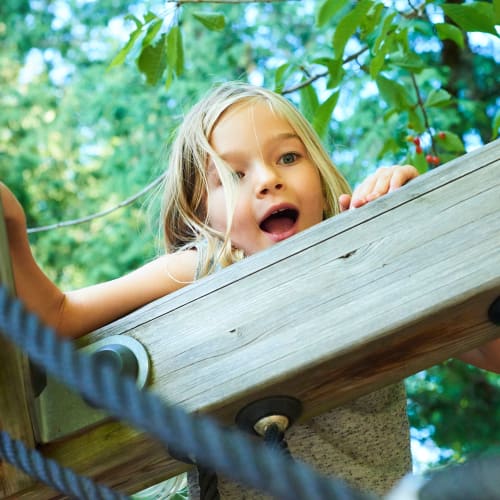 a young girl on the playground at Howard Gilmore Terrace in La Mesa, California