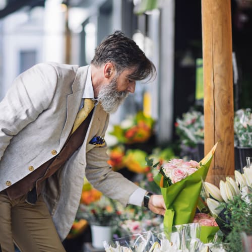 a resident looking at some flowers near  Queens Way in Norfolk, Virginia