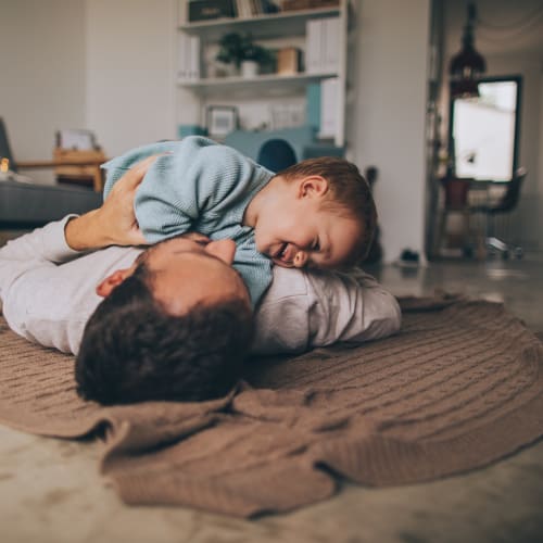 a resident father and daughter playing on the floor at Sandpiper Crescent in Virginia Beach, Virginia