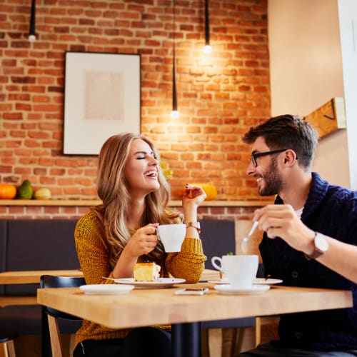 A couple having a coffee at The Village at NTC in San Diego, California