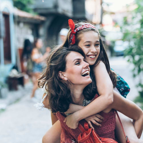 a mother and daughter walking down the street smiling at The Village at New Gosport in Portsmouth, Virginia