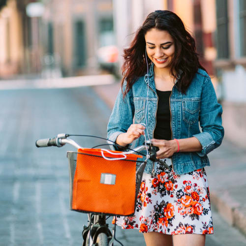 a resident pausing on her bike at The Village at New Gosport in Portsmouth, Virginia