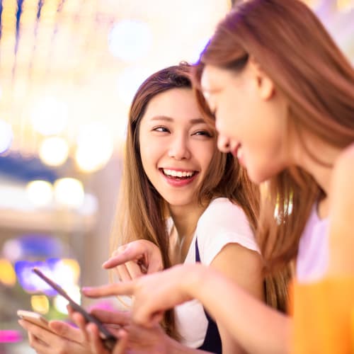 residents laughing at a cellphone at The Village at New Gosport in Portsmouth, Virginia