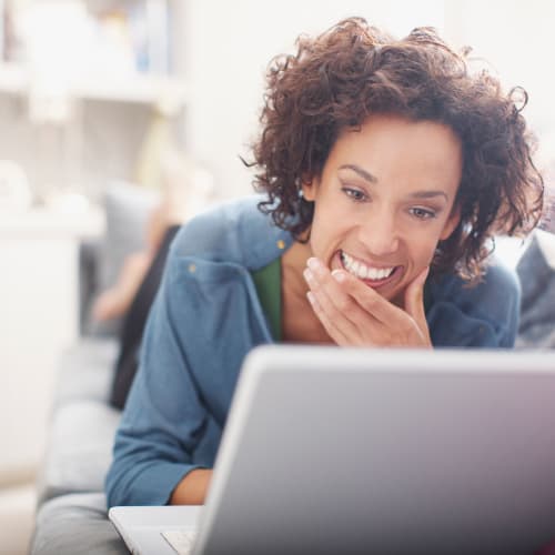 a resident smiling ta her computer at Longshaw Road in Annapolis, Maryland