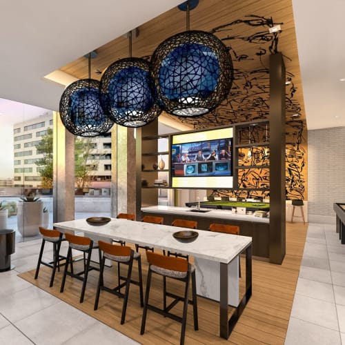 Stunning resident lounge with ample seating options, a large flatscreen TV, shuffleboard and billiards at Solaire 8200 Dixon in Silver Spring, Maryland