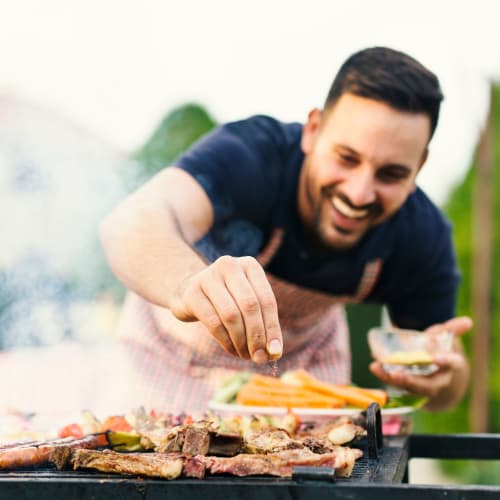 A resident grilling a meat in a picnic area at Geiger Ridge in Quantico, Virginia