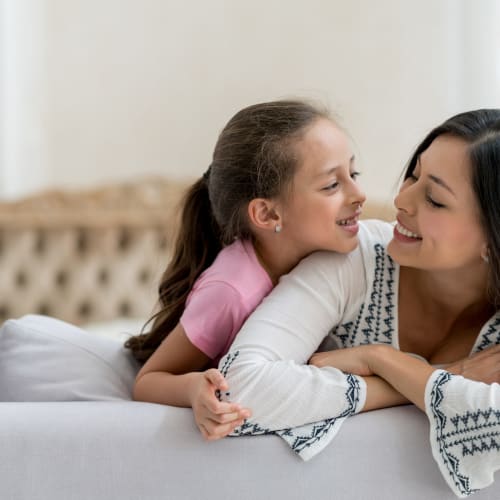 a mother and daughter smiling on the couch at Ramona Vista in Ramona, California