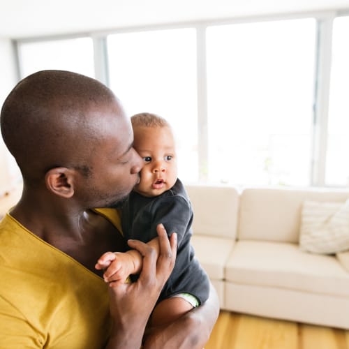 a resident holding his infant at Ramona Vista in Ramona, California