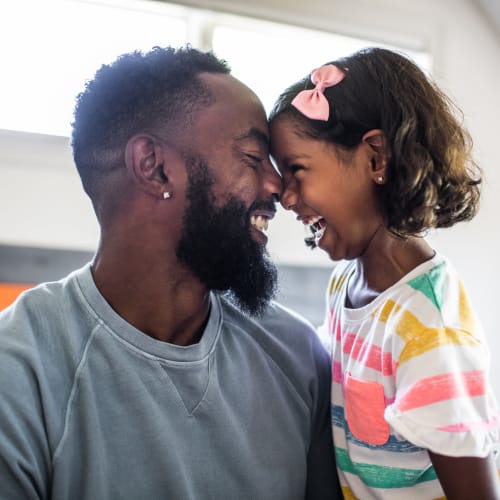 Father and child smiling at each other at Rivertop Apartments in Nashville, Tennessee