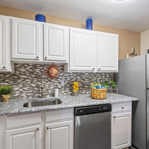Open concept model kitchen with stainless steel appliances at Silver Spring Station Apartment Homes in Baltimore, Maryland