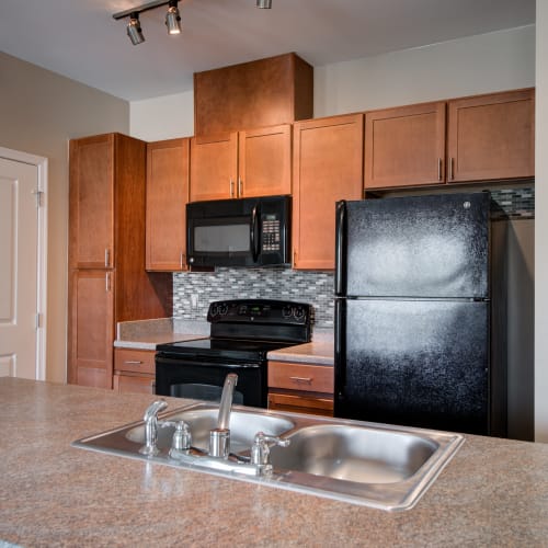 Kitchen with faux wood flooring at Orchard Meadows Apartment Homes in Ellicott City, Maryland